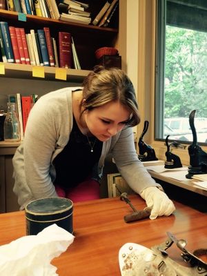 Student examining a historical artifact